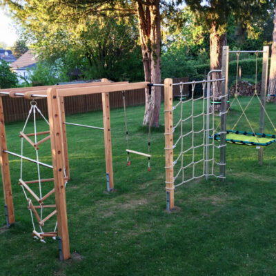 Individually planned climbing frame with nest swing