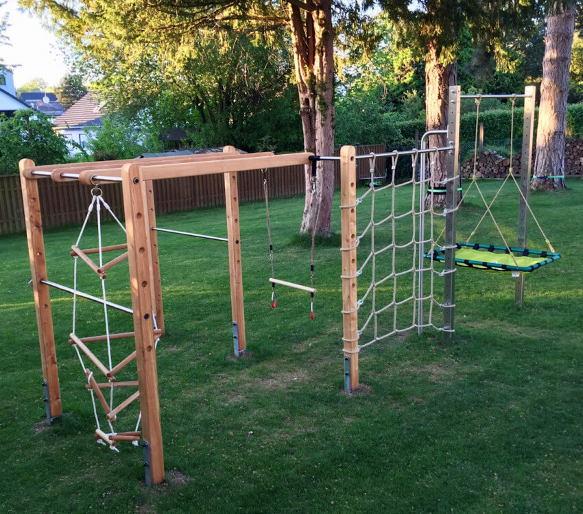 Individually planned climbing frame with nest swing